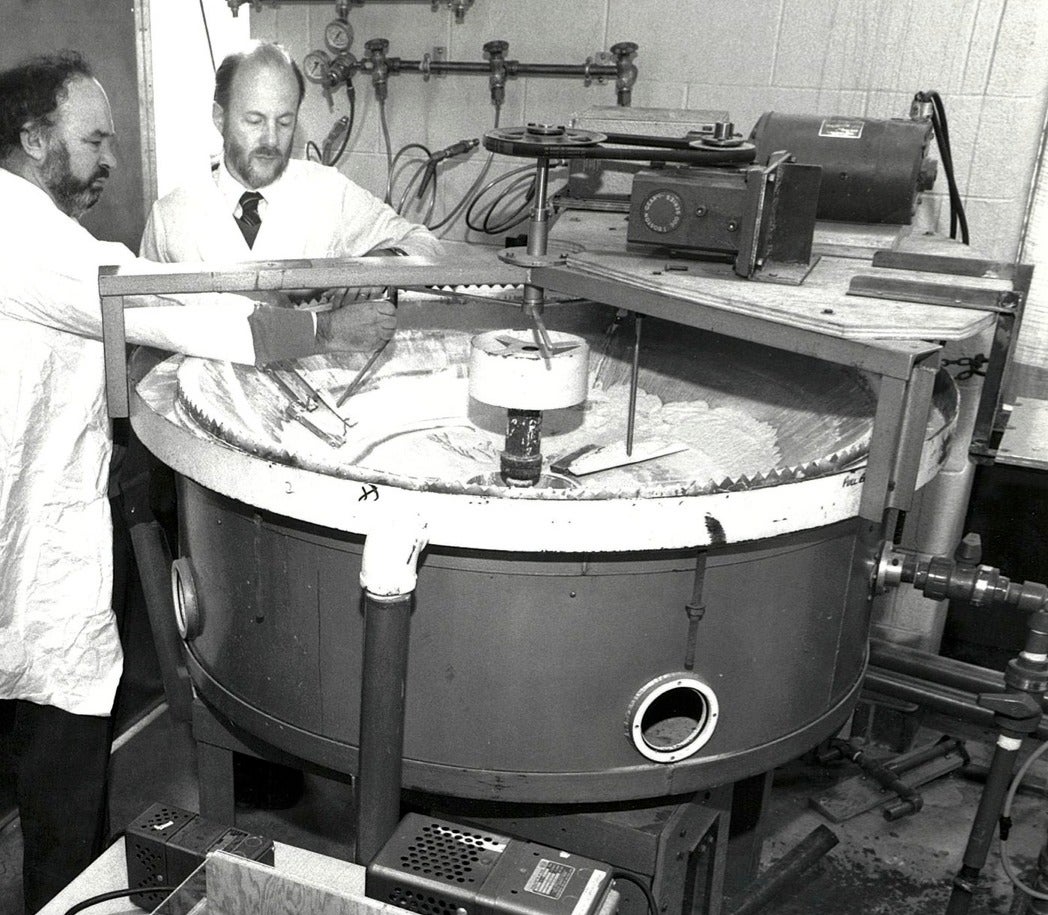 Professor Peter Silveston (left) and Professor Robert Hudgins work with a model sewage treatment aerator in their lab.
