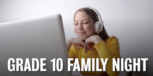 A young woman wearing headphones smiles as she looks at a laptop.
