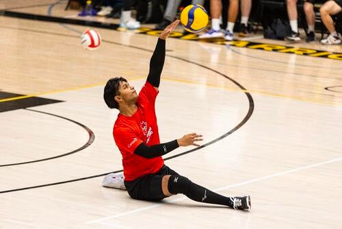 Nasif Chowdhury putting in a serve at an exhibition event at the Waterloo Physical Activities Complex.