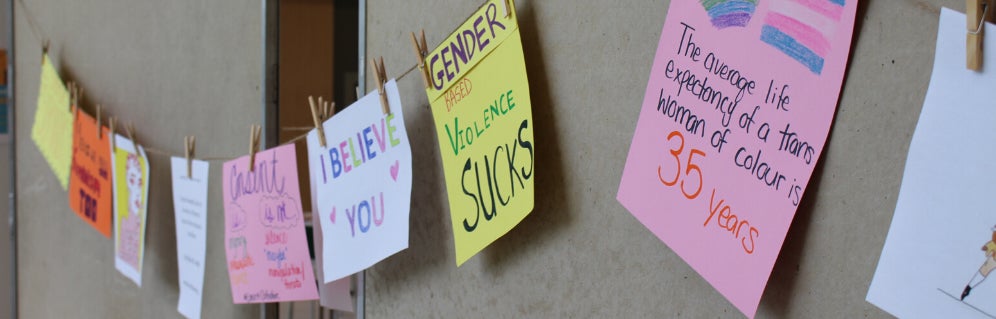 A Consent Clothesline with consent-related slogans hanging from it.