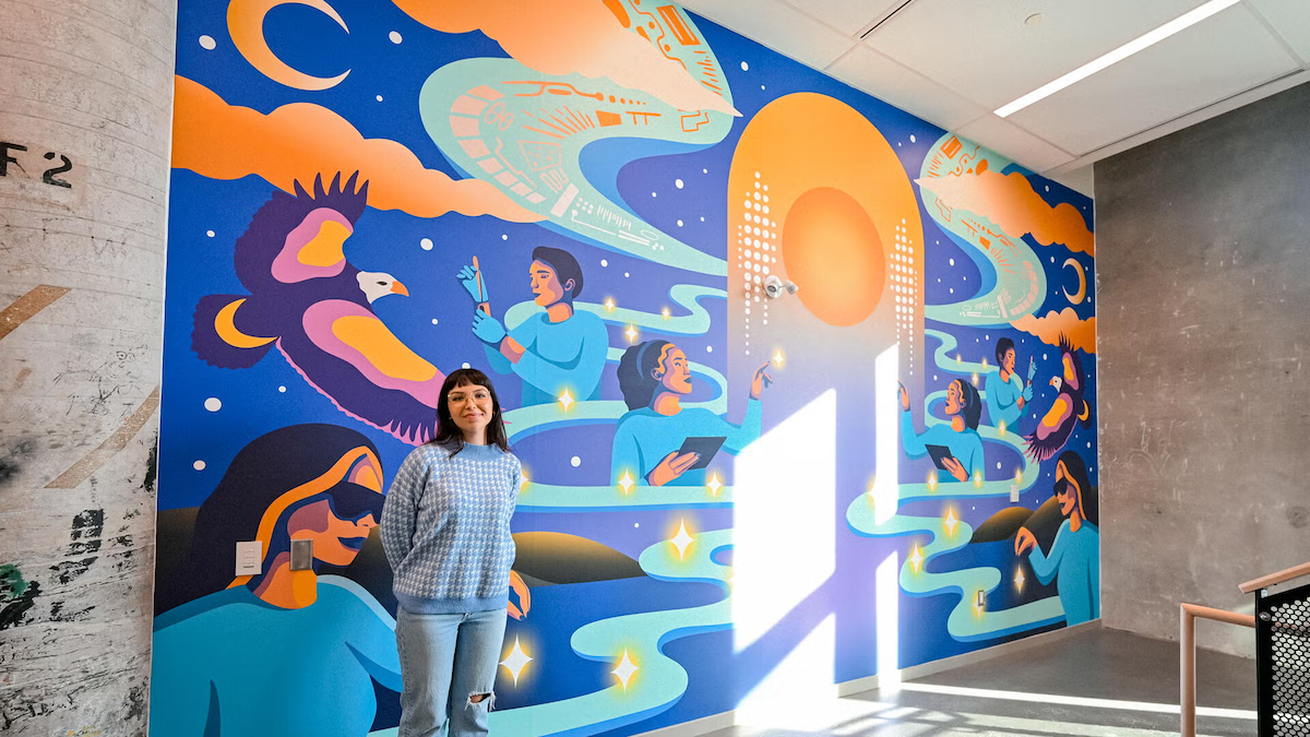Artist Alanah Jewell stands in front of the mural.