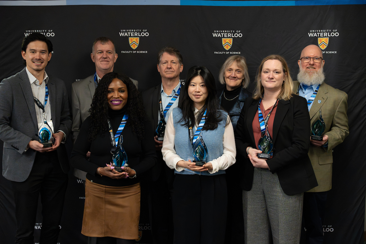 Science alumni award winners pose with their awards.
