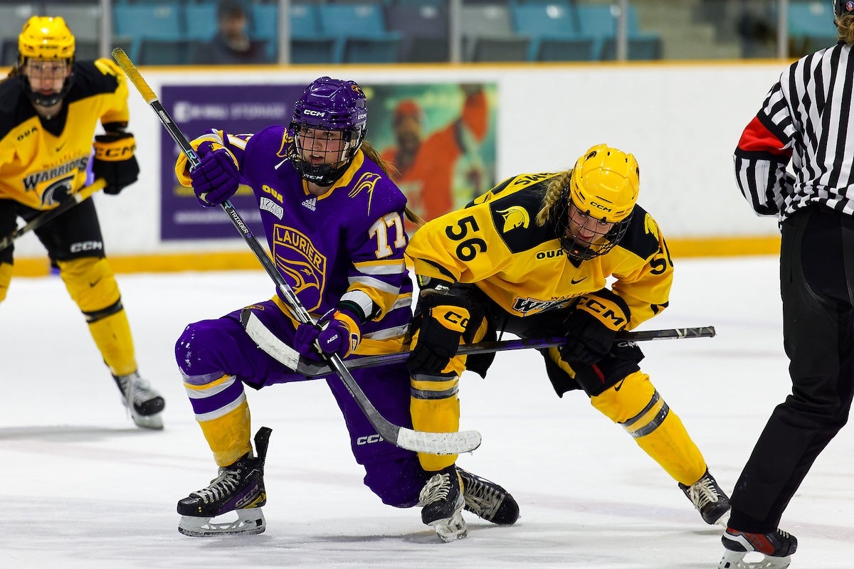 Brooke Williams wins a faceoff against a Laurier centre.