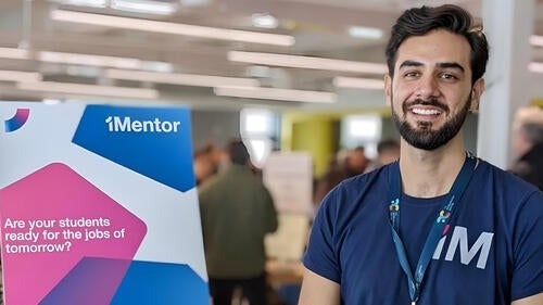 Esteban Veintimilla stands next to a 1Mentor zap banner.