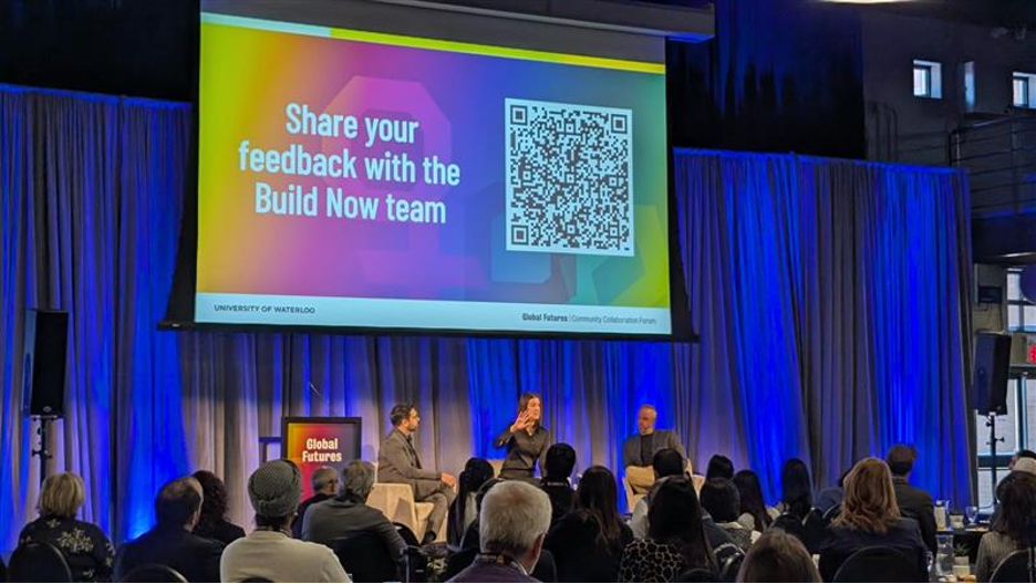 Panelists sit on stage at the Global Futures community event.