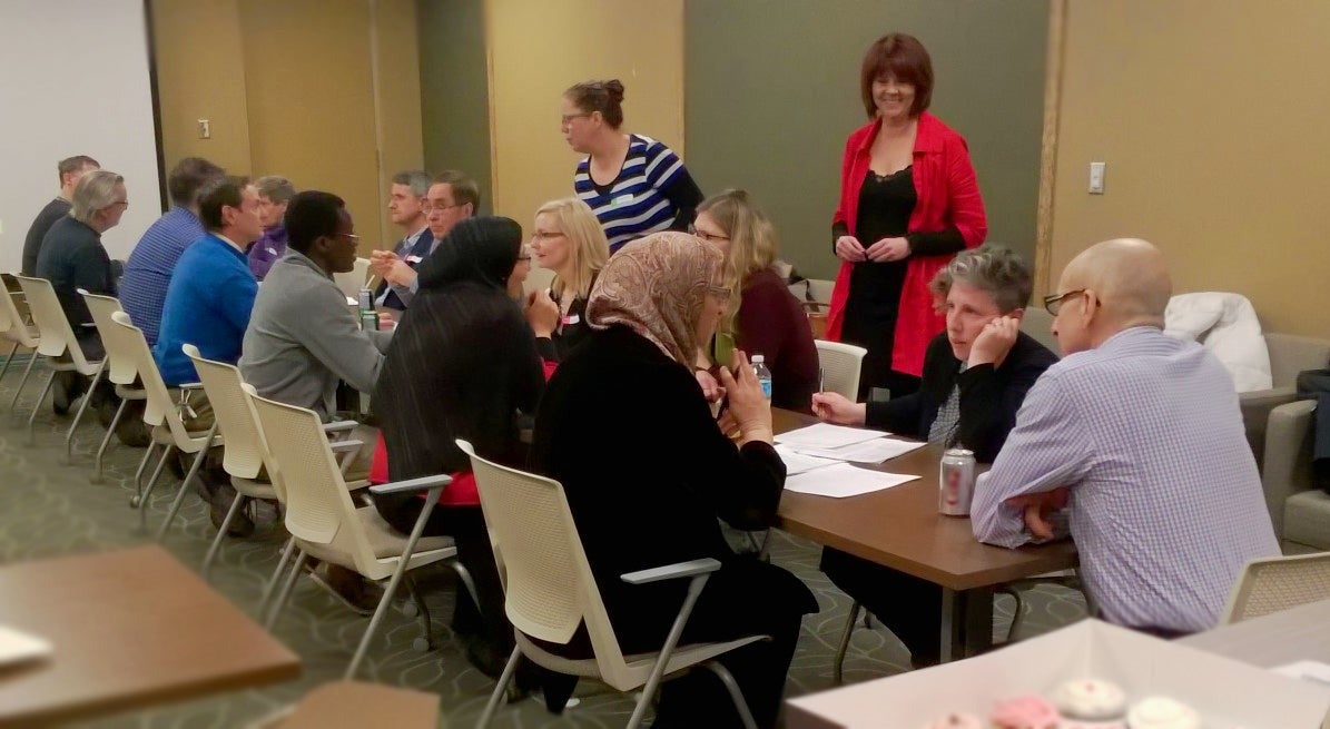 Participants in the pedagogical speed dating roundtable converse.