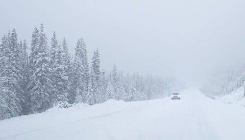 A vehicle travels on a winter ice road.