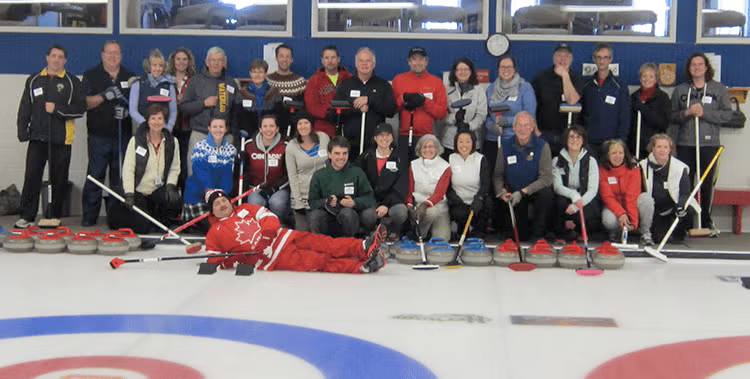 Participants in the Hagey Bonspiel gather together on the ice.