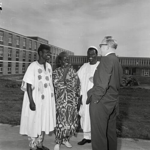 Nigerian engineering students (left to right) Adesanya (Ade) Akadri, Oluremi (O’Remi) Balogun, and Samuel Ilechukwu (1941-2013) chat with Douglas Wright, Dean of Engineering in 1961.