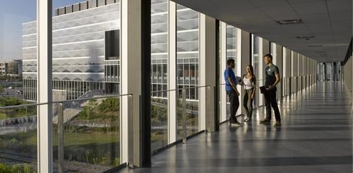 Students stand inside the bridge connecting Engineering 7 to the rest of campus.