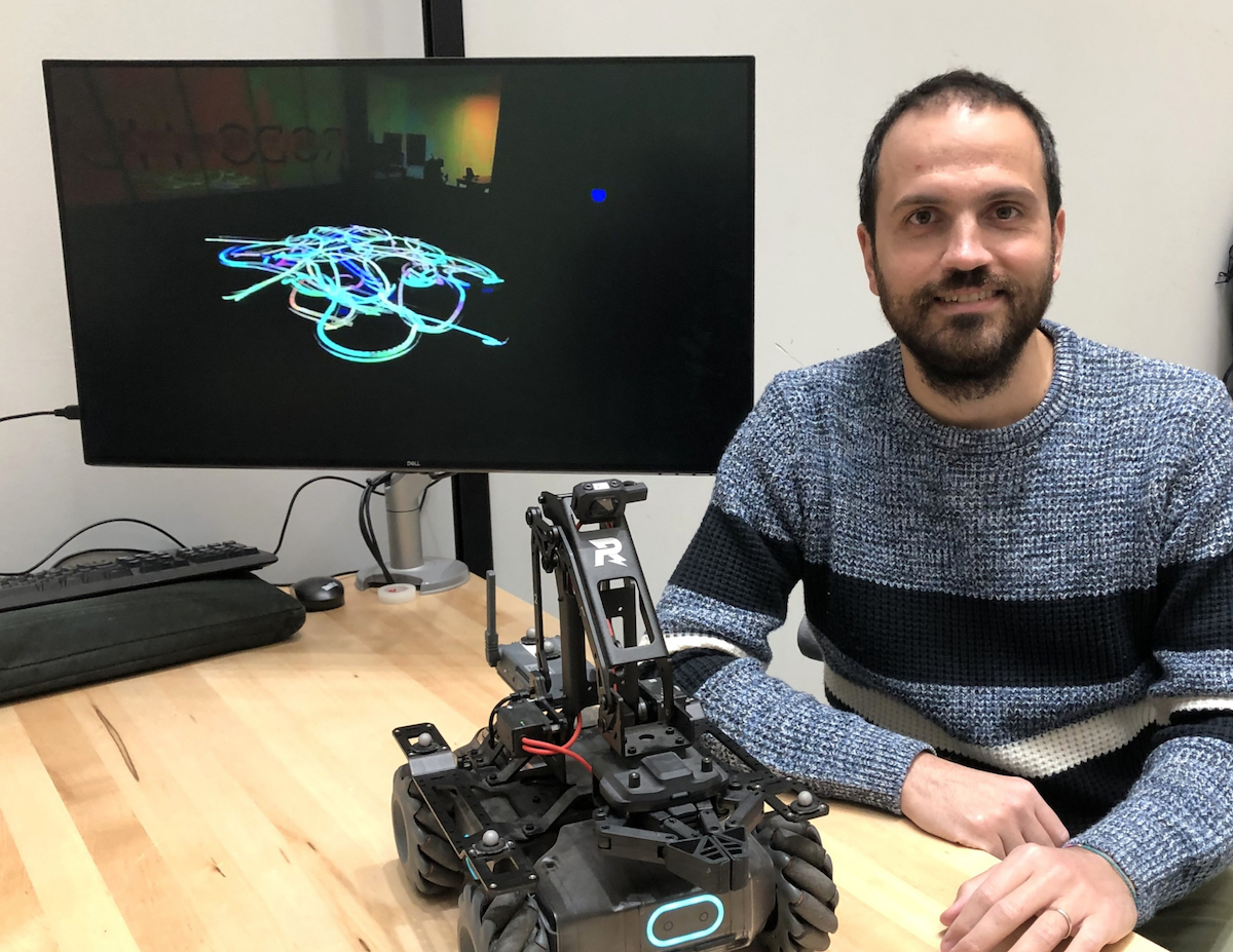 Dr. Gennaro Notomista with a robot and computer screen.