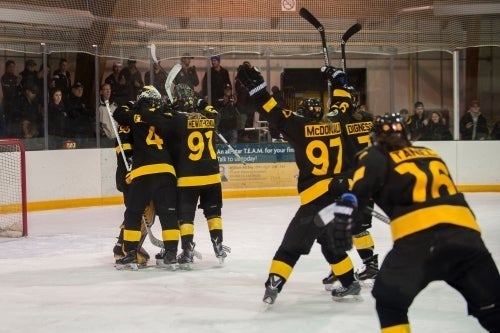 Warrior Women's Hockey team members celebrate a victory.