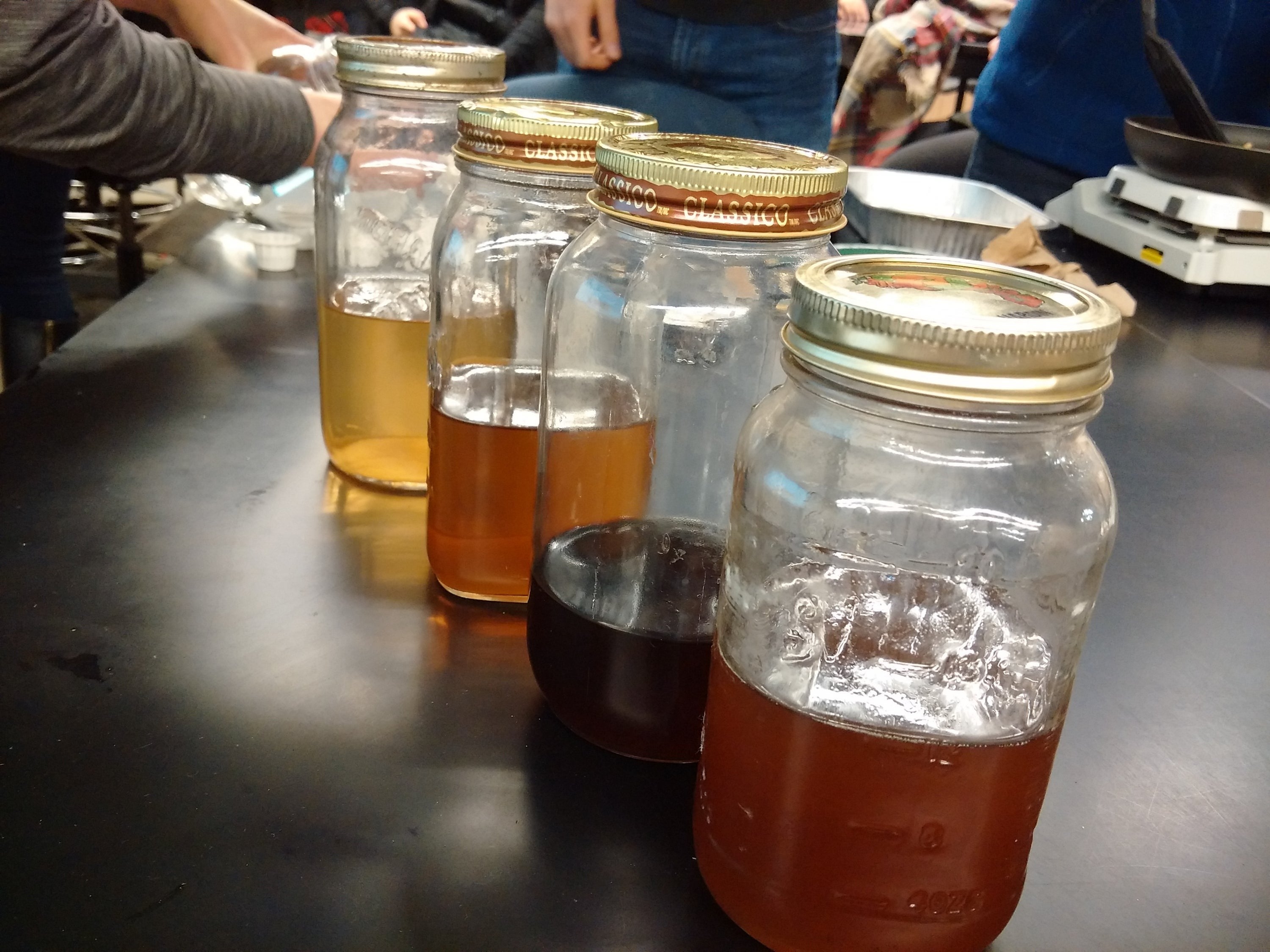 Mason jars full of maple syrup.