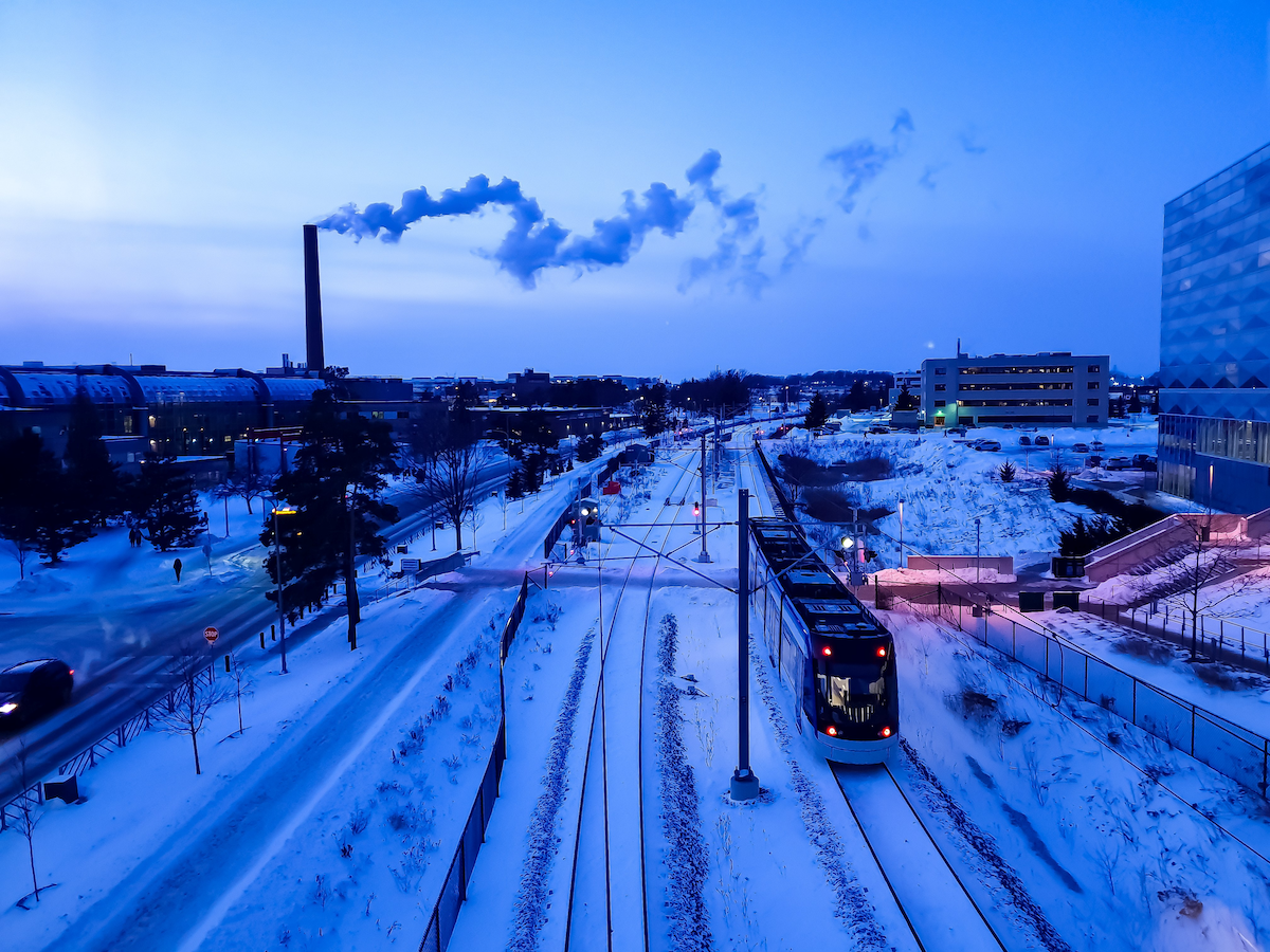 An ION train glides on the tracks separating the main campus from the University's East Campus in winter.