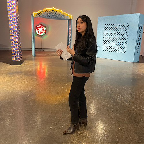 Jude Abu Zaineh speaks in front of her art installation.