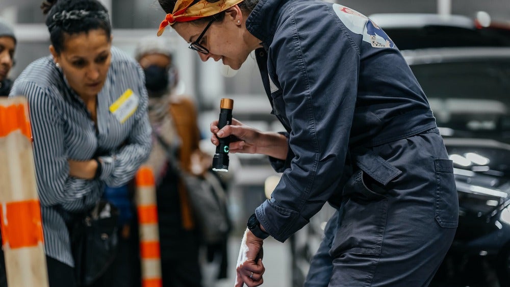 Stefanie Bruinsma holds a flashlight at an AutoCate demonstration event in Toronto.