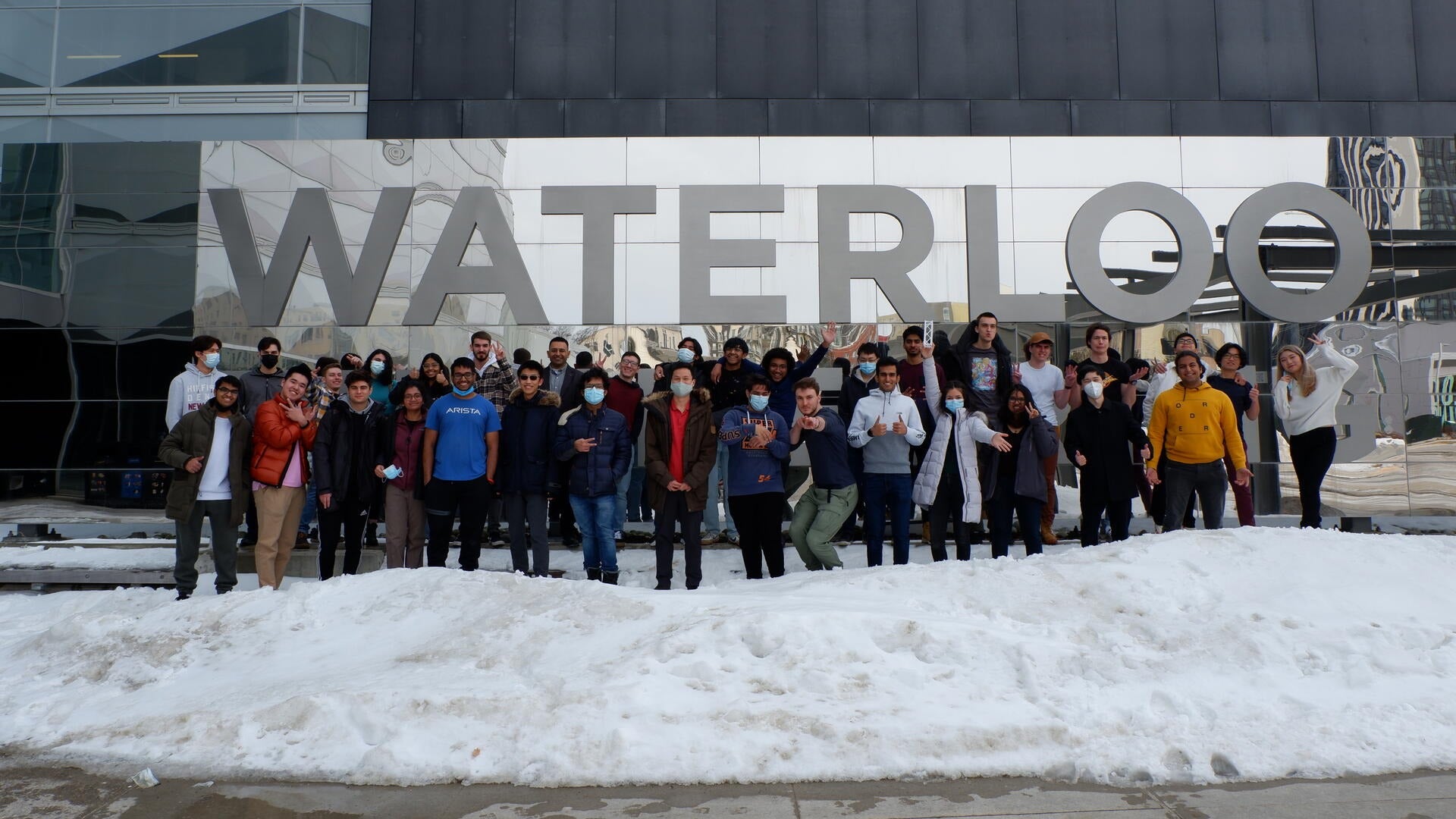 Members of the UW Orbital student team congregate outside of Engineering 7.