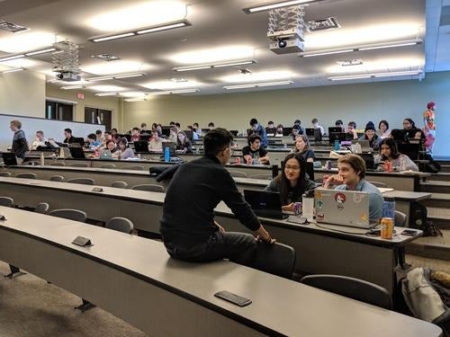 Game Jam participants work in groups to develop video games.