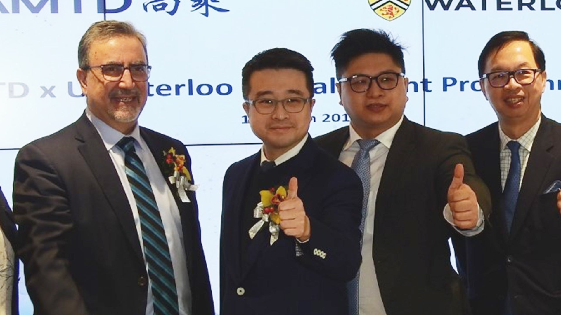 Feridun Hamdullahpur, Calvin Choi, and other representatives on stage.