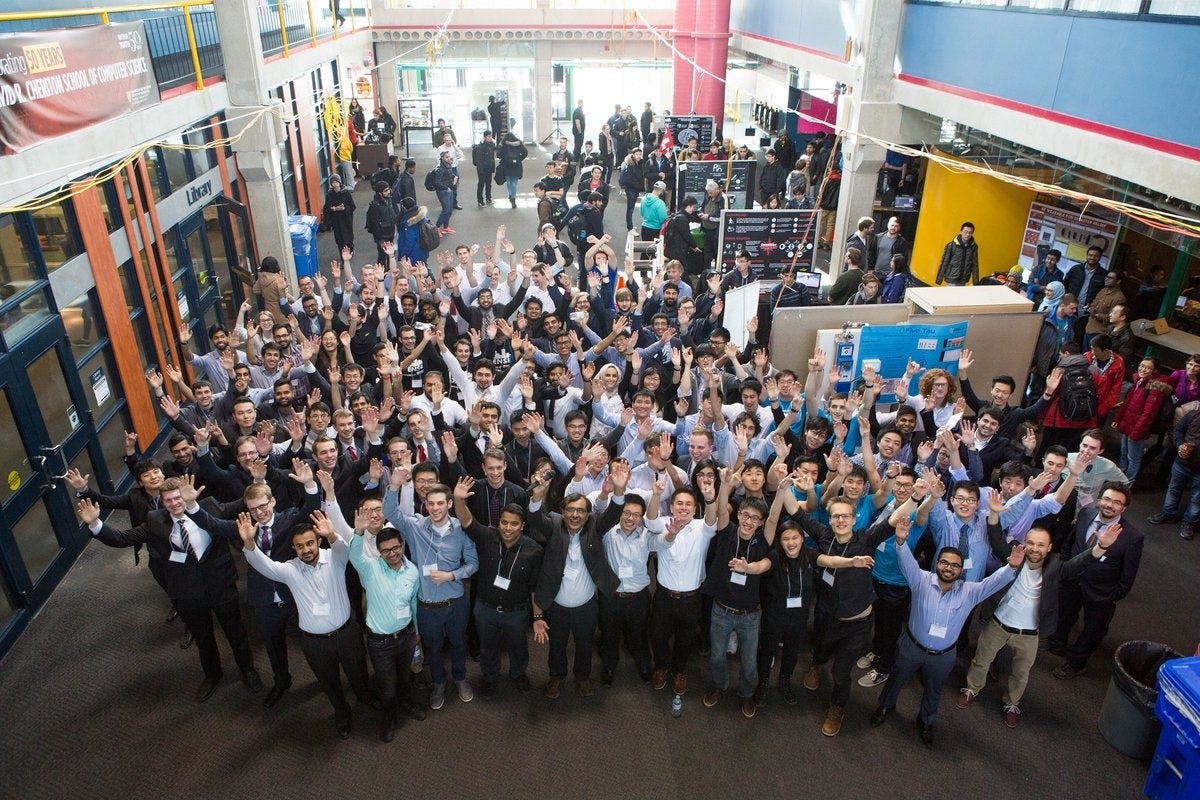 Engineering students wave from the floor of the Davis Centre.