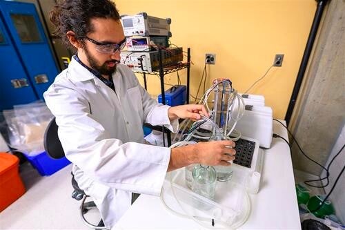 Keith Cleland works with a saltwater cell battery.