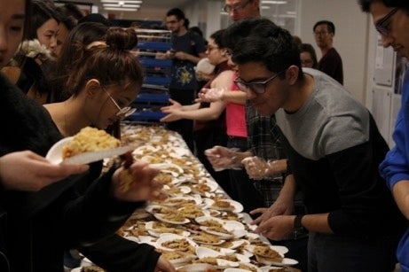 Students hand out free slices of pie in non-COVID times.