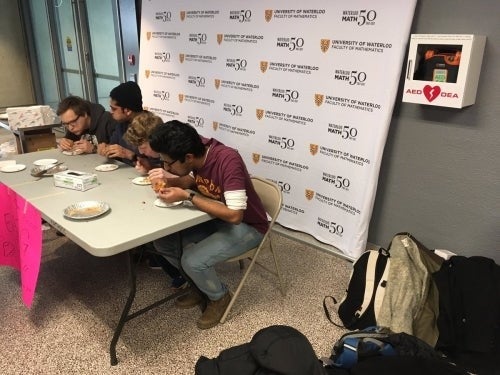 Students engage in a pie-eating contest as part of the Pi Day festivities yesterday.