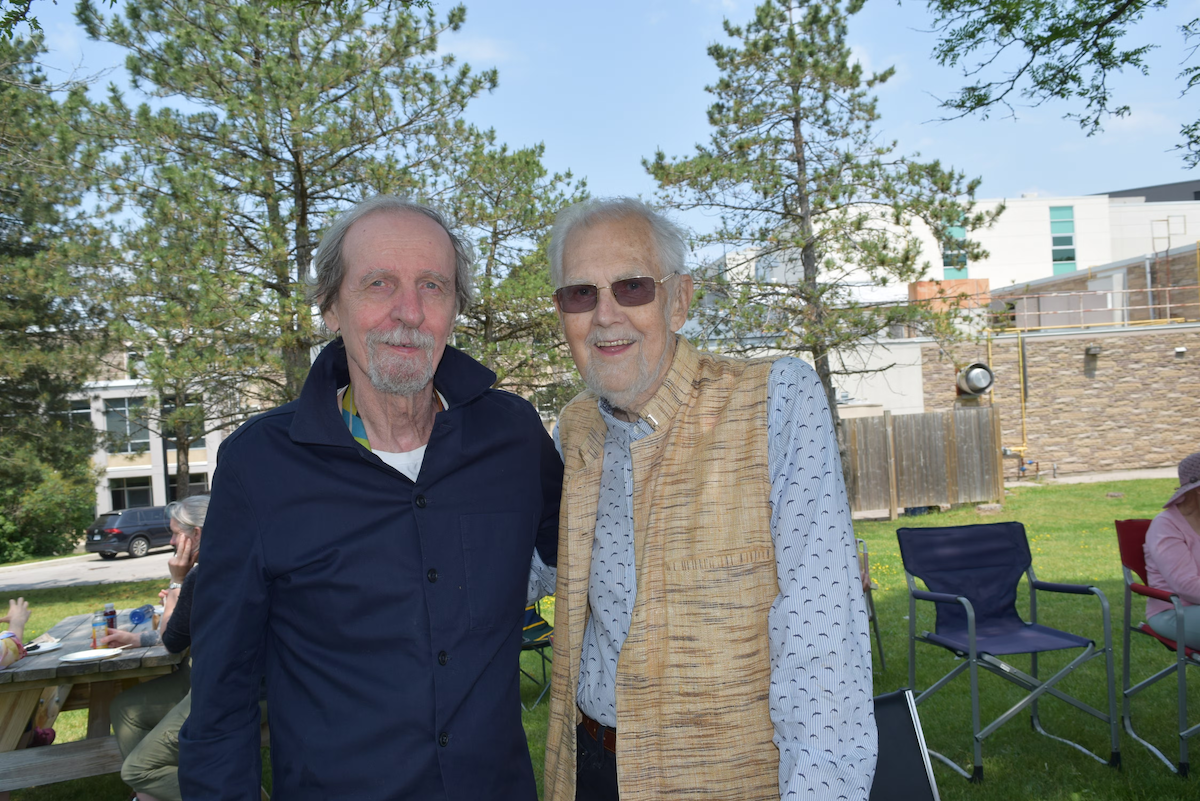 Dr. Darrol Bryant (right) with Ed Jewinski (left) at Renison's summer BBQ in 2023.
