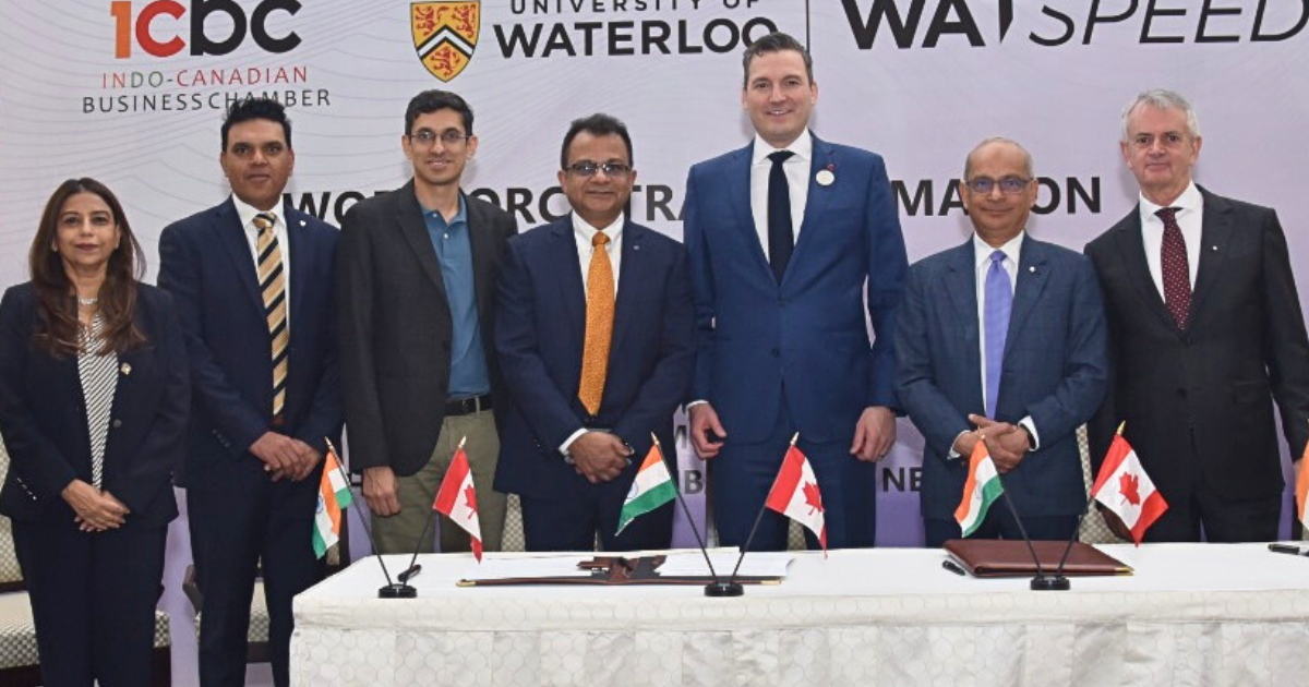 Waterloo delegation members Vivek Goel, Mary Wells, and Sanjeev Gill pose with the Honourable Evan Solomon at the AI Impact Summit