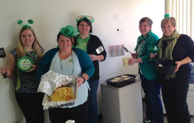  Angela Rooke, Carrie Nickerson, Patty Robinson-Angel, Julie MacMillan, Tasha Glover hold pancakes and utensils.