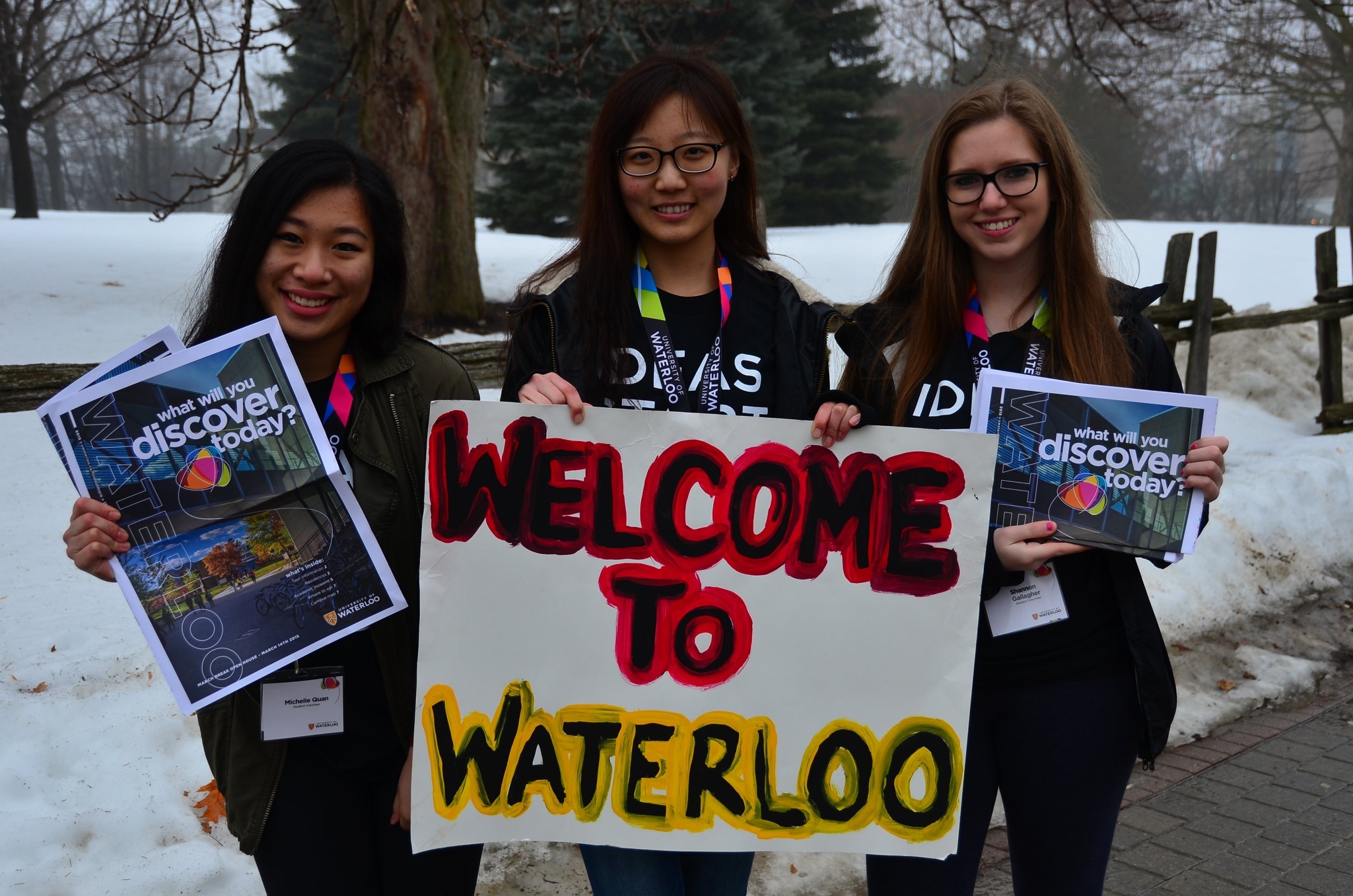 Volunteers holding "Welcome to Waterloo"