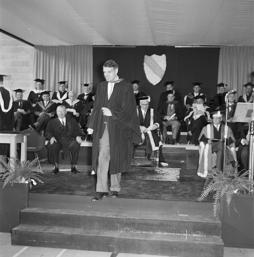 Ron Mullin in convocation regalia leaves the stage at the first convocation in 1960.