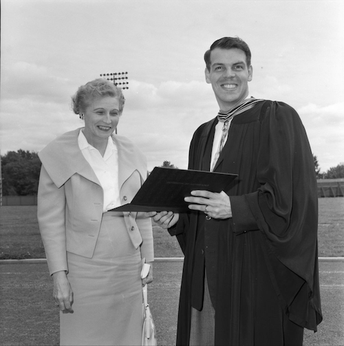 Ron Mullin smiles as he holds his diploma. His mother looks on proudly.