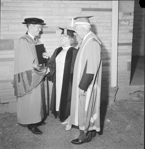 Ronald Mullin wears PhD convocation regalia as he speaks with Dr. Dorothy Turville and President J.G. Hagey