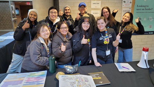 Student ambassadors give a thumbs up.