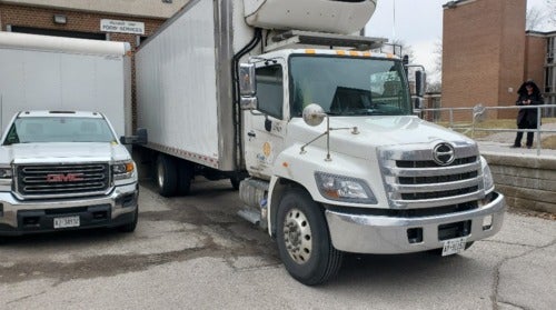 A Food Bank truck loads up at the Student Village loading dock.