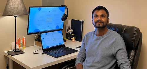 Gokul Raj Pullagura sits at a computer workstation.