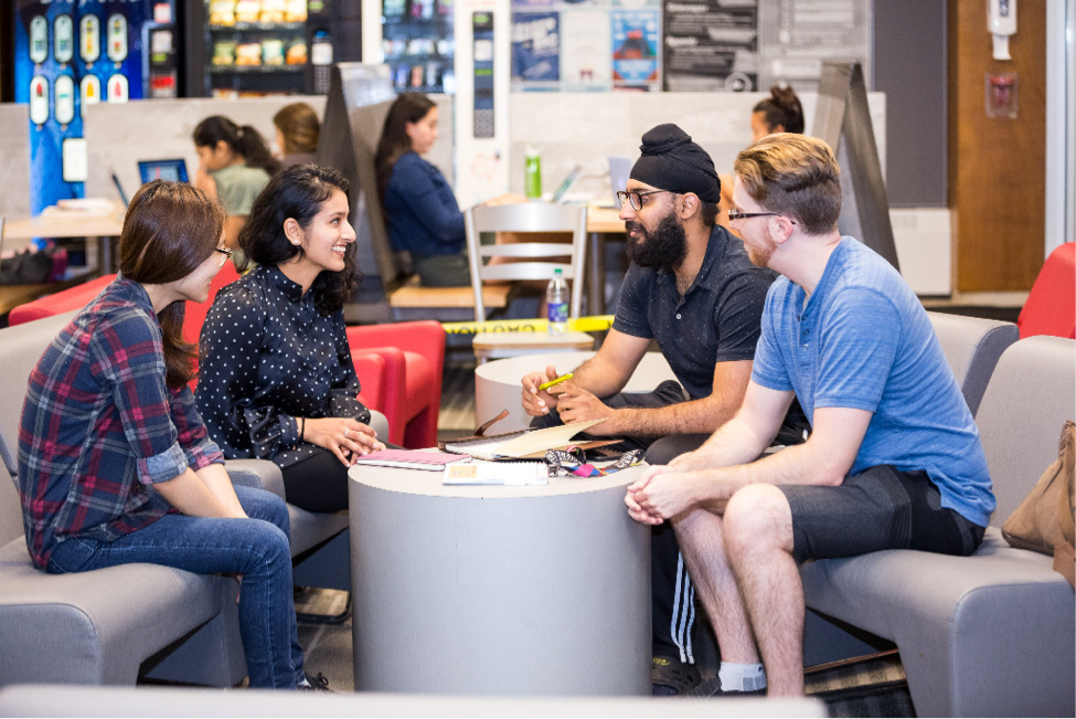 Alumni and students converse in a residence lounge.