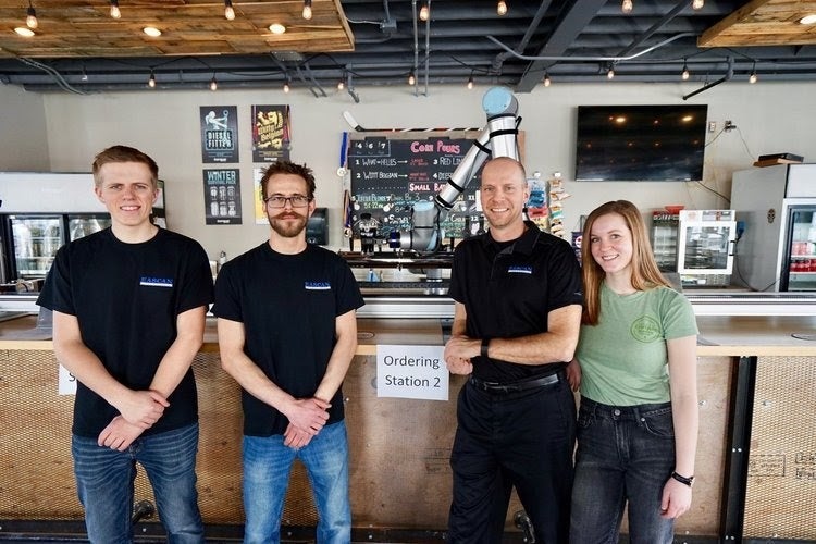 Caleb Dueck, his co-workers, and a robot bartender.