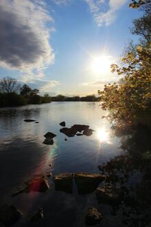 The sun sets over a lake.