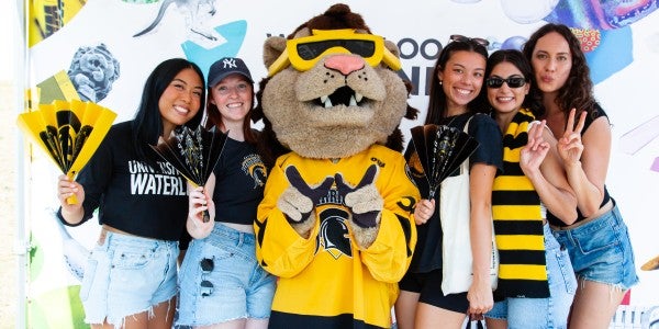 Students celebrating in Waterloo school colours with mascot