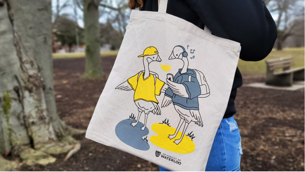 A person carries a tote bag that shows the winning goose design.