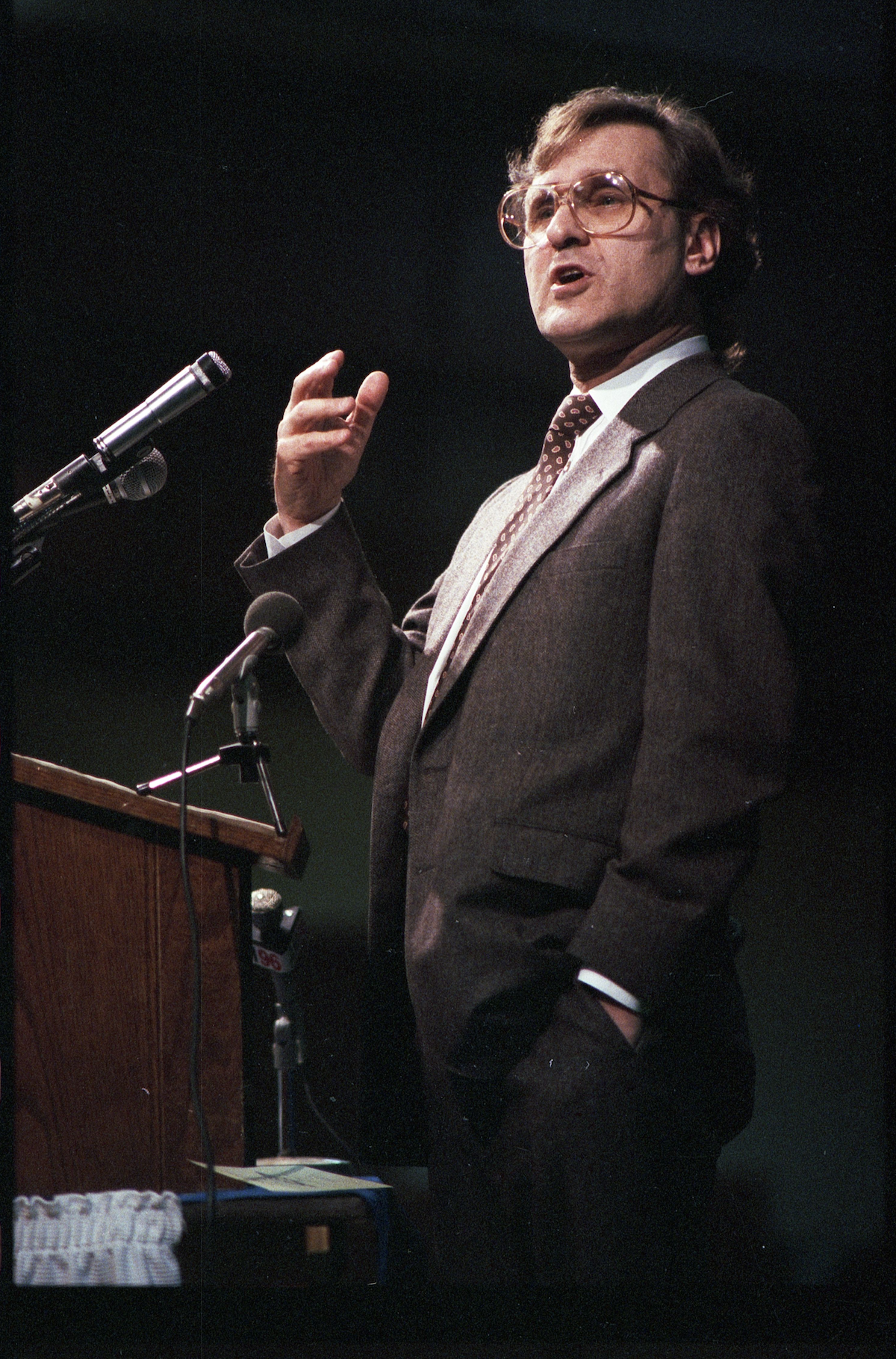 Stephen Lewis gestures while speaking at a lectern.