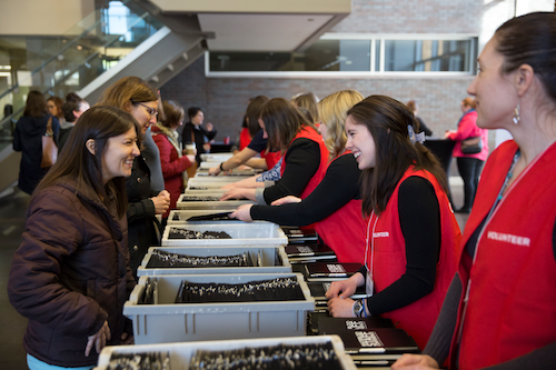 Volunteers help staff members get registered at the staff conference.