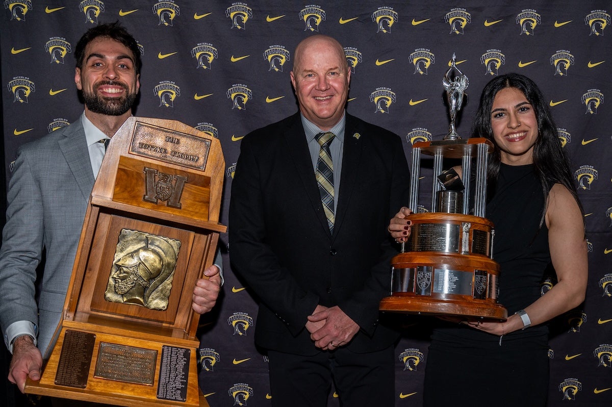 Cameron Seth and Niki Shemirani pose with Director of Athletics and Recreation Roly Webster