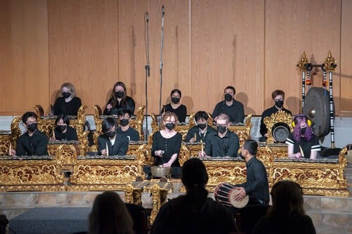 The Balinese Gamelan ensemble performing on a stage.