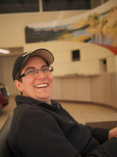 Nadia Ursacki smiles as she sits in the front row of a theatre.