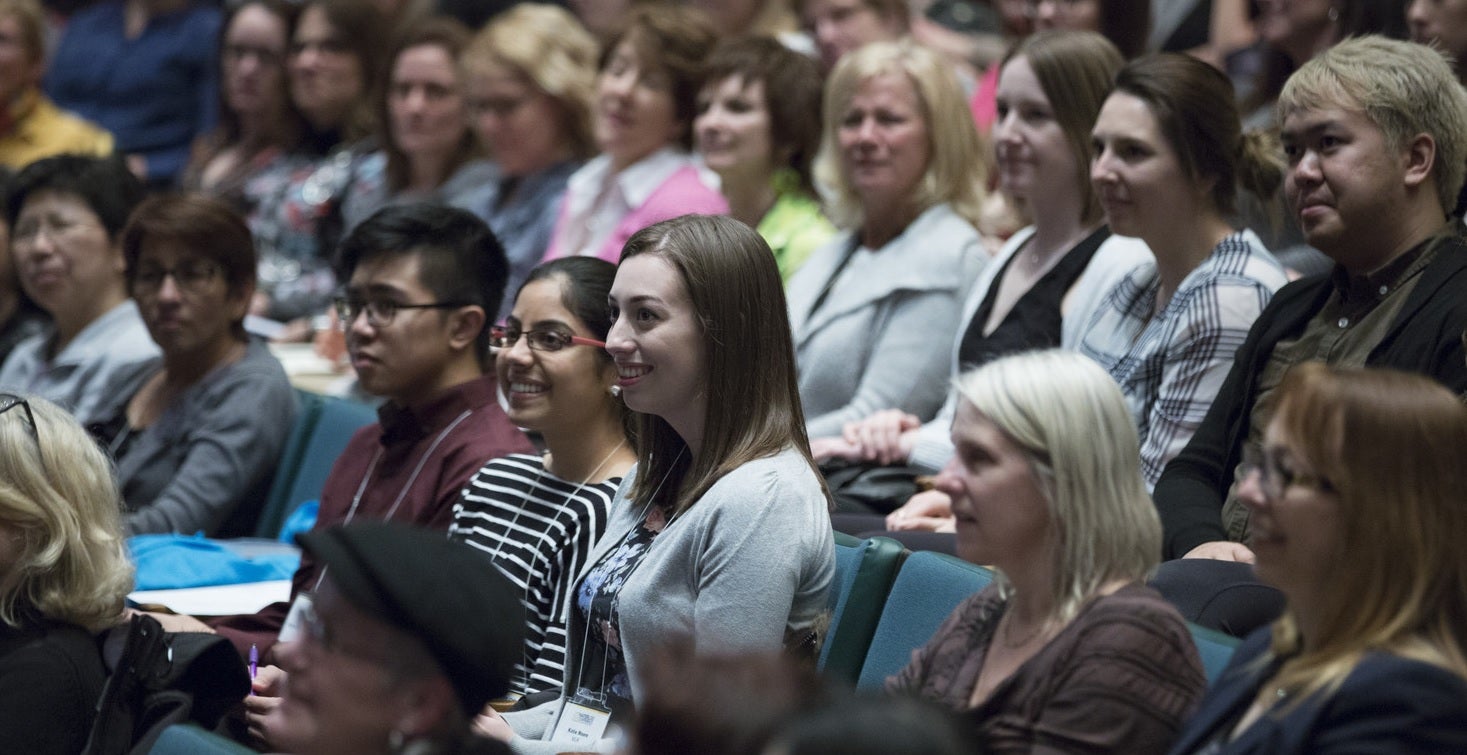 Staff members in the audience at a staff conference keynote address.