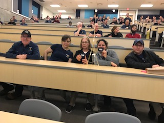 Staff members build marshmallow towers.