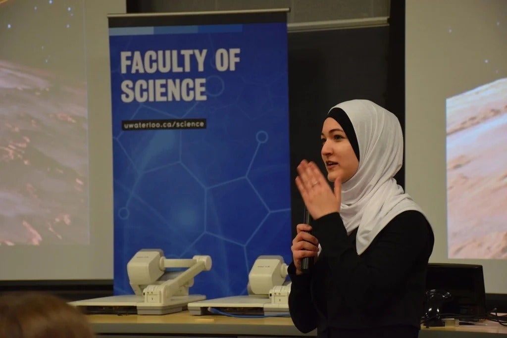 A female student speaks at the conference.